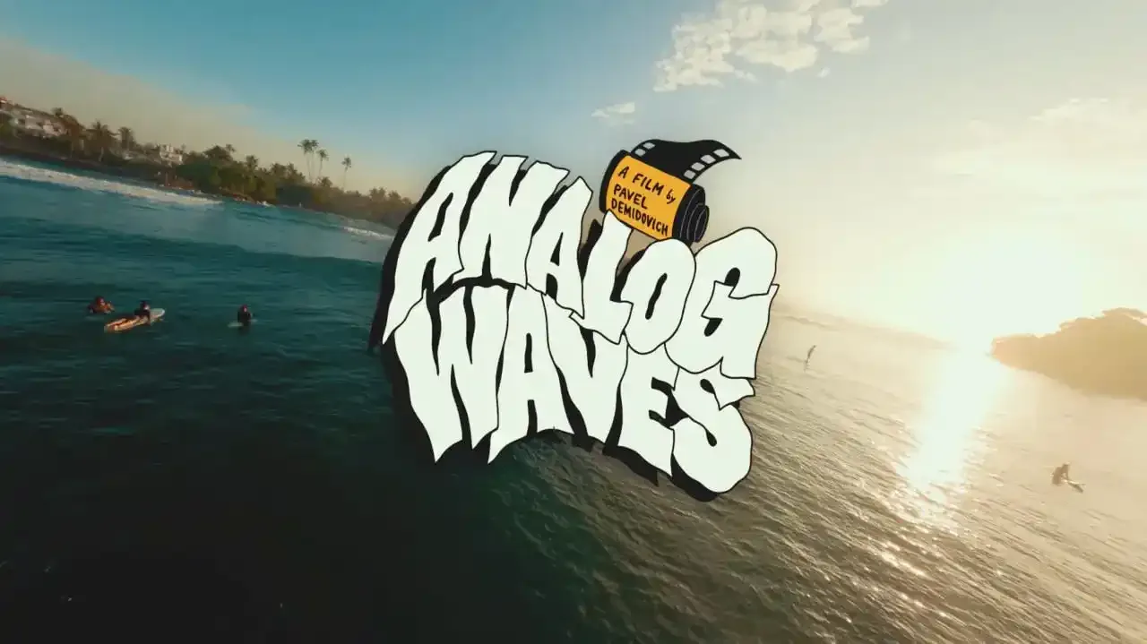 Poster for the film “Analog Waves”: ocean at sunset, surfers on the waves and the words “Analog Waves” in heavy display type.